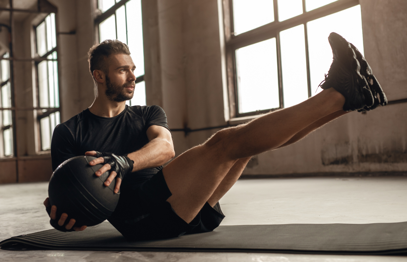 Man doing core exercise with medicine ball