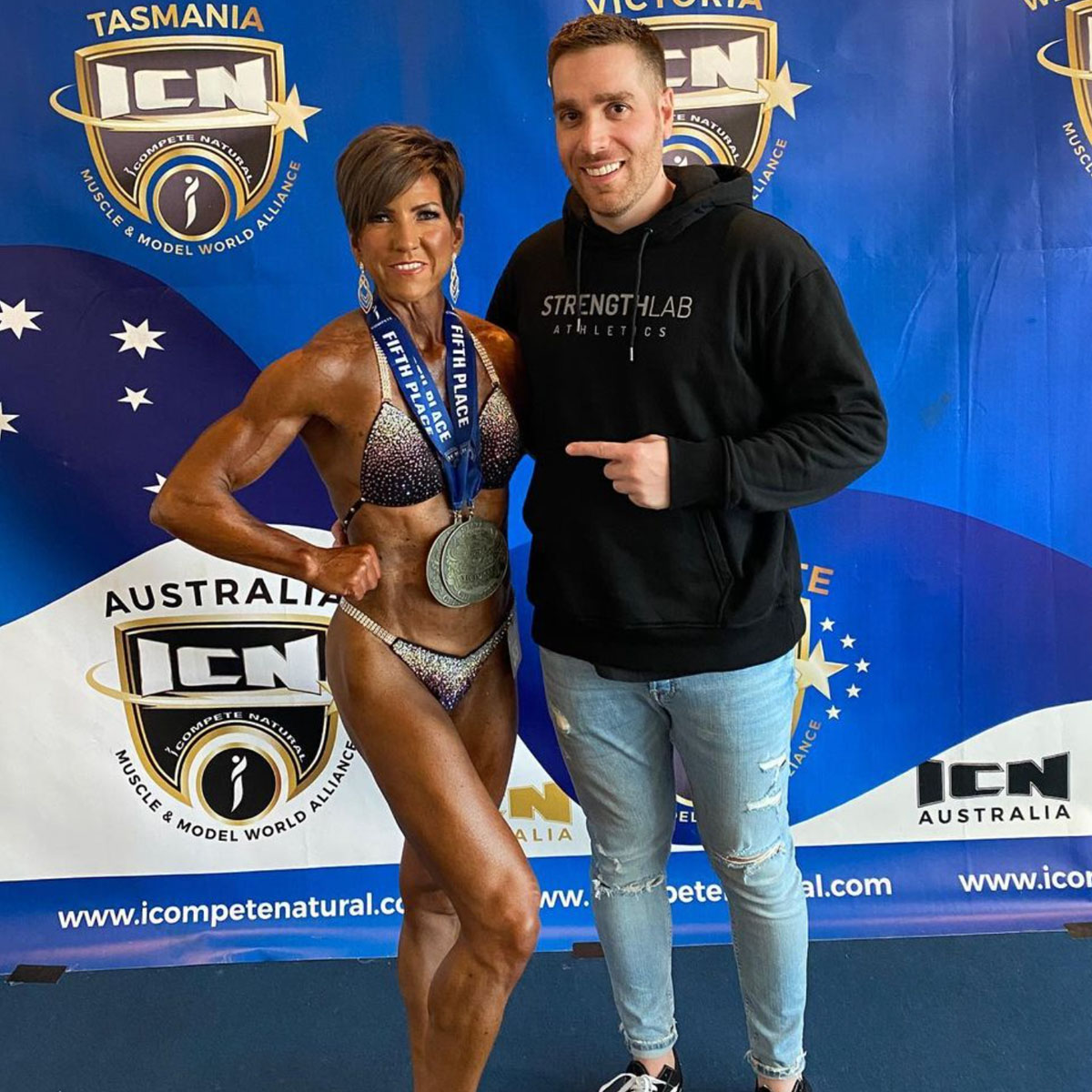 Confident competitor smiling post-performance at ICN event