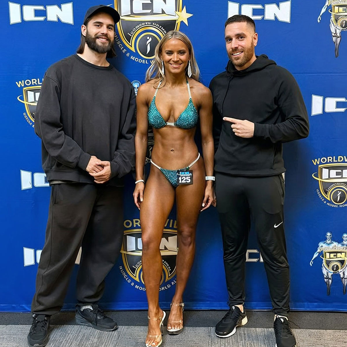 Strength Lab coaches supporting a competition prep client at their fitness event