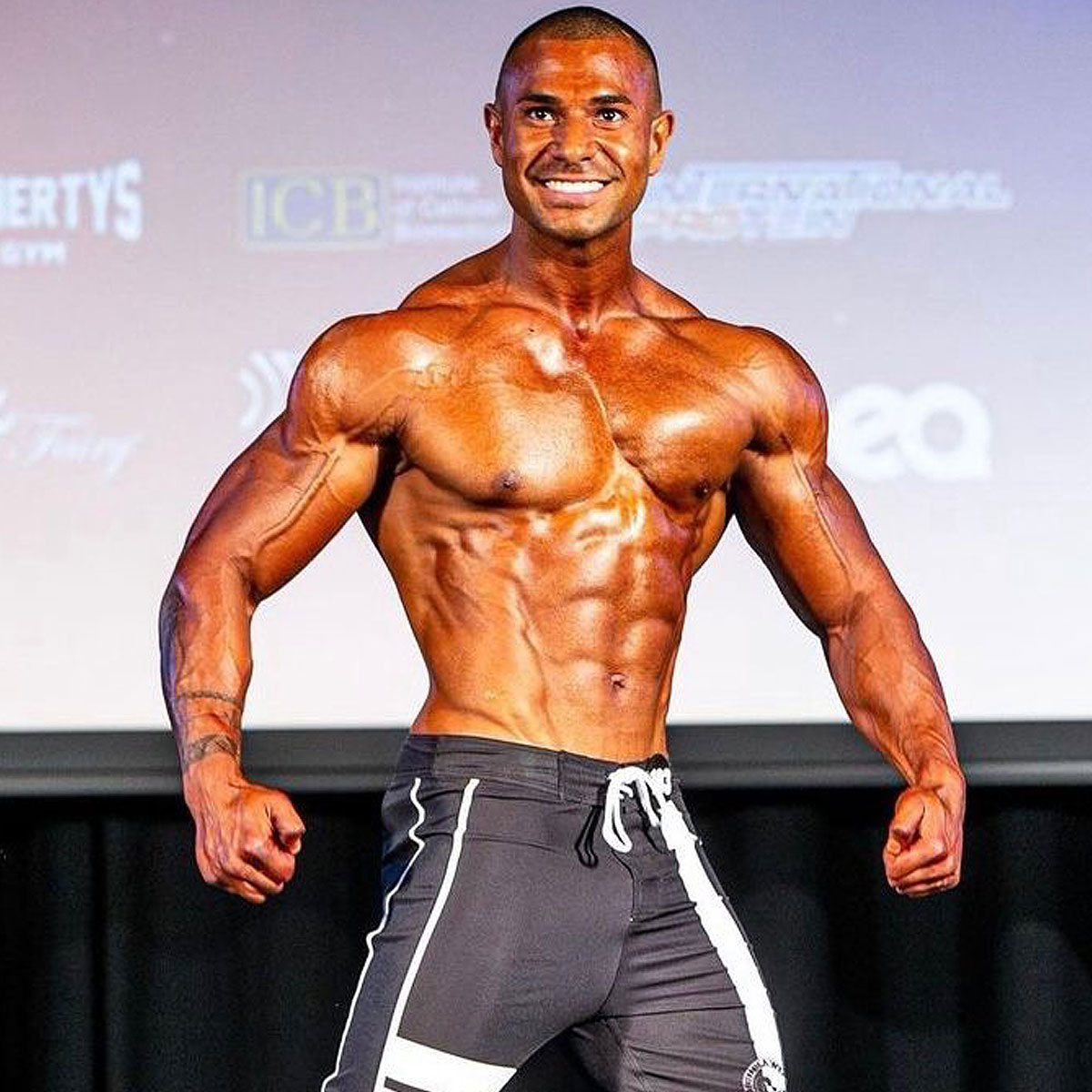 Male athlete in peak condition taking the stage at competition