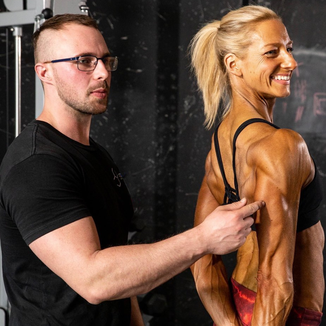 Strength Lab coach supporting a female athlete during competition prep training