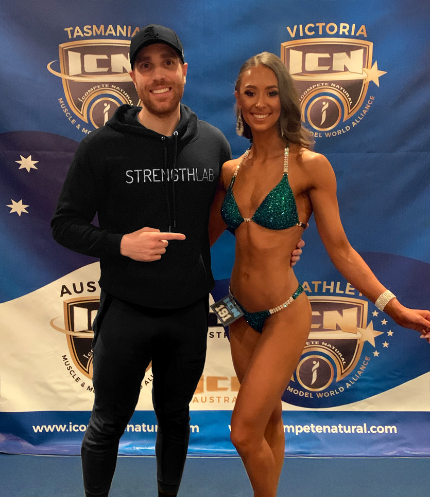 Strength Lab coach Andrew with competition prep client at fitness event